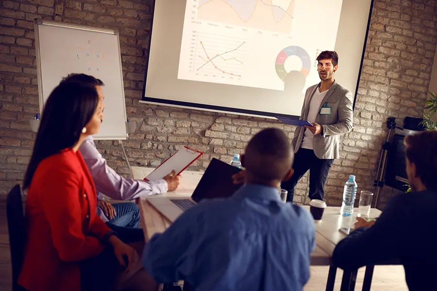 Presenter delivering a winning pitch deck using AI-powered tools to a business team