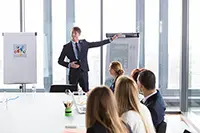 Startup pitch deck presentation during an investor meeting, showcasing a professional speaker explaining pitch deck slides and structure to a focused audience.