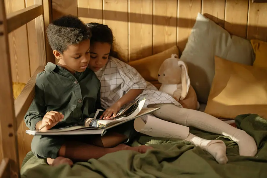 Two children reading a book together, symbolizing storytelling techniques for startups to connect with audiences and drive action