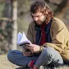 Profile photo of Andrei Ciobanu, a man sitting outdoors and reading a book.