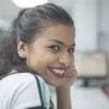 Profile photo of Isabella Gomez, a woman smiling brightly indoors.