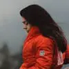 Profile photo of Priya Shah, a woman wearing a red jacket standing outdoors.